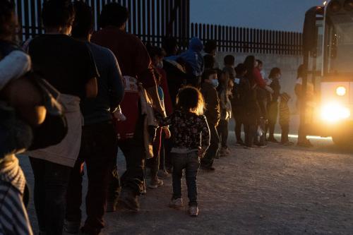 Asylum-seeking migrants' families make a line to board a bus as they wait to be transported by the U.S. Border Patrols after crossing the Rio Grande river into the United States from Mexico in Penitas, Texas, U.S., March 26, 2021. Source: REUTERS/Go Nakamura