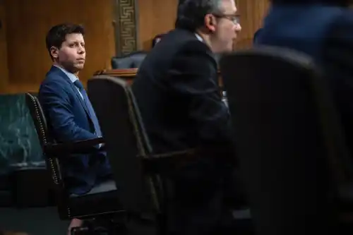 Samuel Altman, left, CEO, OpenAI, listens while Gary Marcus, right, Professor Emeritus, New York University, offers his opening statement during a Senate Committee on the Judiciary - Subcommittee on Privacy, Technology, and the Law oversight hearing.