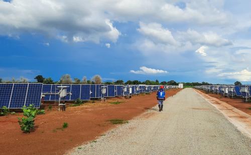 person working on vegetation control on solar site, Africa