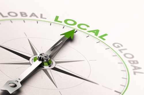 3D illustration of a compass with needle pointing the word local.