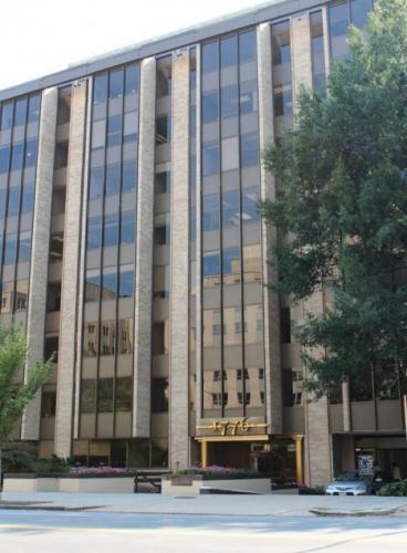 Tall brown building with 1776 address in large gold numbers over the entrance