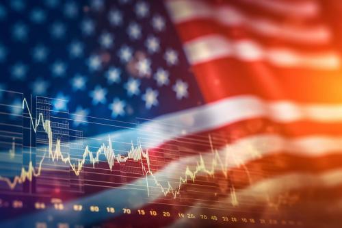 Photo of an American flag and stock market chart representing the economy and patriotism.
