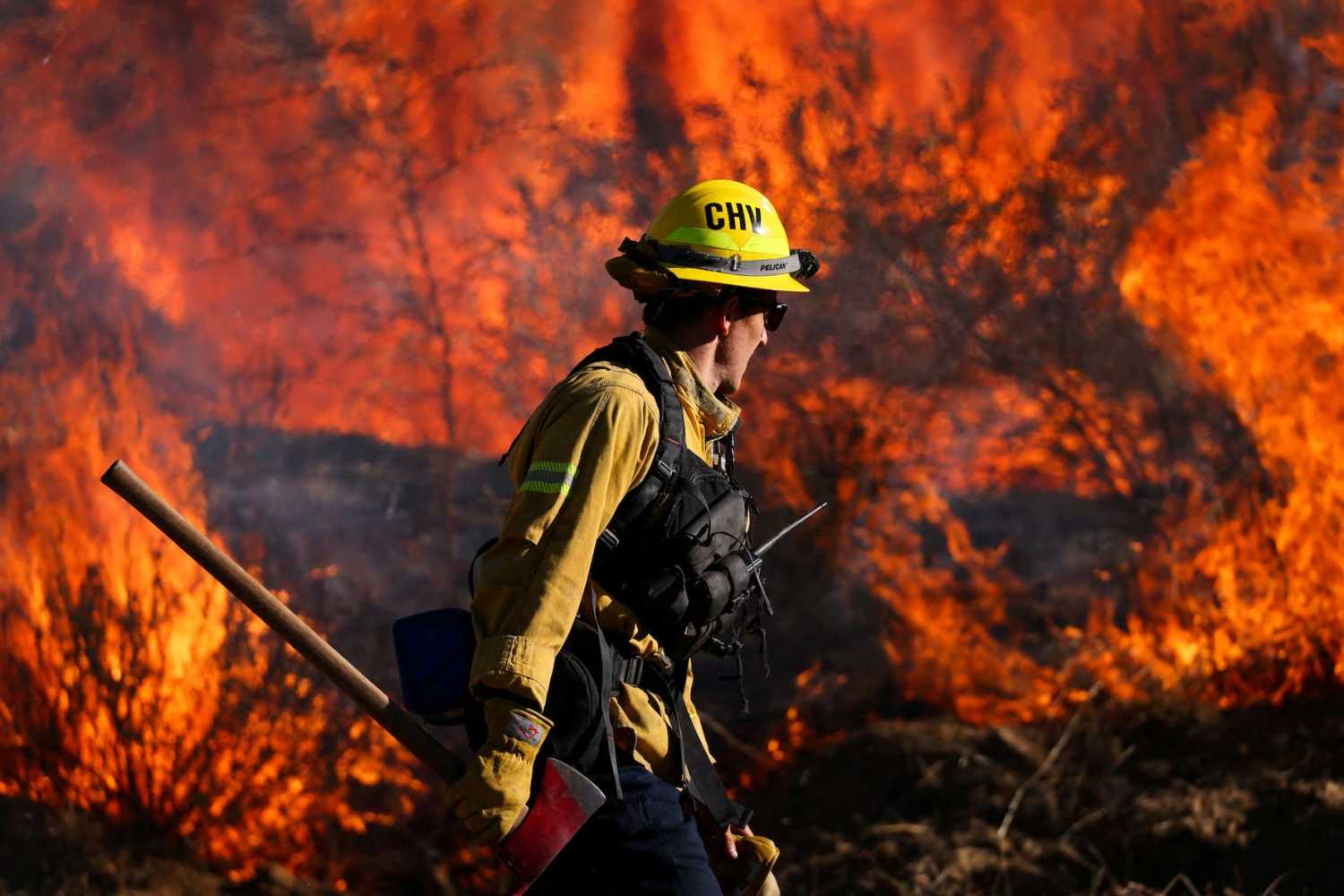 A firefighter works to extinguish the Highland Fire, a wind driven wildfire near Aguanga, California, U.S., October 31, 2023.