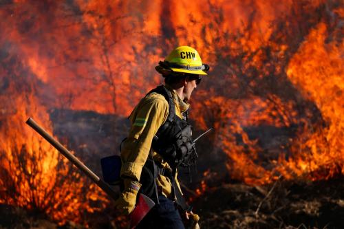 A firefighter works to extinguish the Highland Fire, a wind driven wildfire near Aguanga, California, U.S., October 31, 2023.