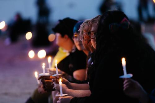 A gathering of friends, family, classmates and community members in a candlelight vigil for Owasso High School student Nex Benedict illuminate the night in Owasso on Feb. 25, 2024. Benedict, a non-binary teenager, died the day after an altercation in a school bathroom.
