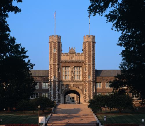 Gothic building with two towers, surrounded by trees