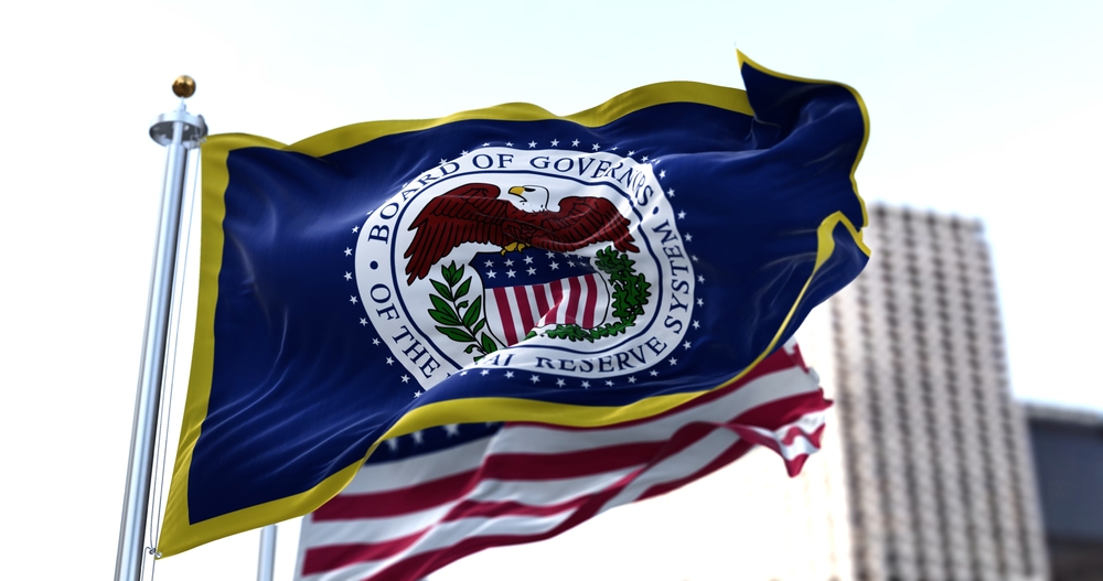 Photo of Federal Reserve System and U.S. flags flying in wind