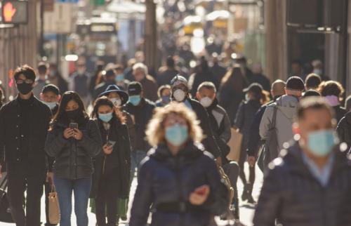 People walking on the street wearing surgical masks