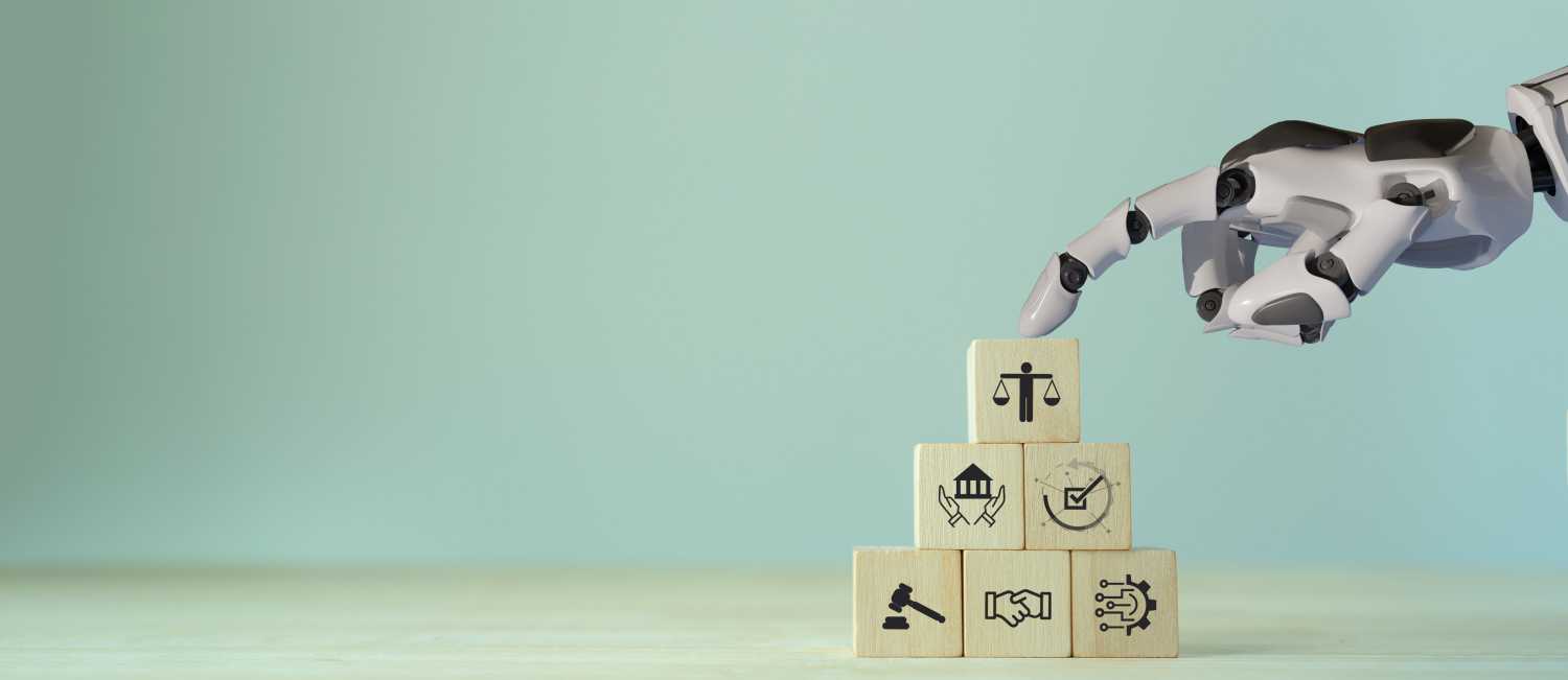 Robotic hand touching wooden blocks with images of ethics and laws