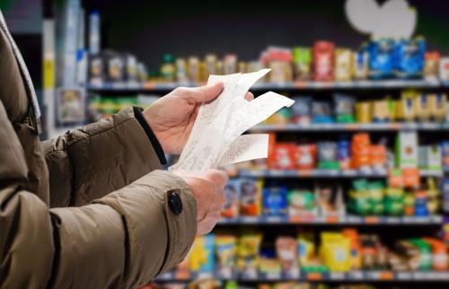 Man looking at receipts in a grocery store