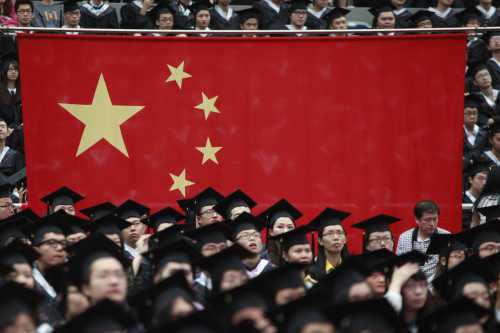 Graduates set next to the Chinese flag during a graduation ceremony at Fudan University in Shanghai, June 28, 2013.