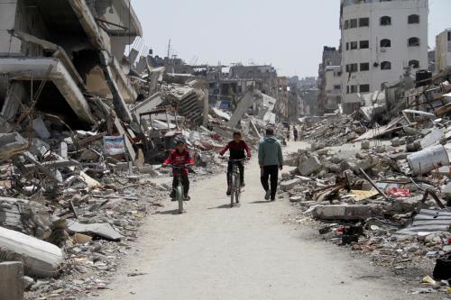 Palestinians ride bicycles past the ruins of houses and buildings destroyed during Israel’s military offensive, amid the ongoing conflict between Israel and Hamas in the northern Gaza Strip, March 31, 2024. Reuters/Mahmoud Issa