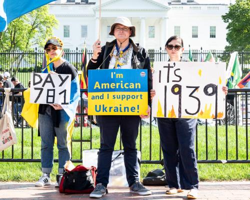 People holding signs in support of Ukraine in front of the White House in Washington, DC.