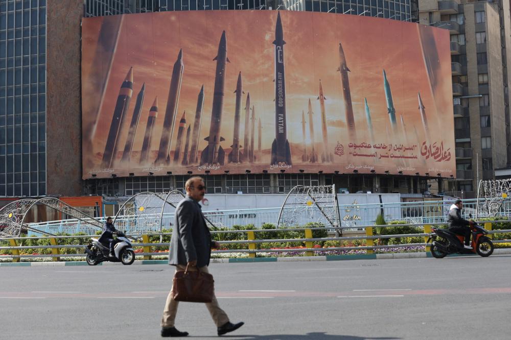An anti-Israel billboard with a picture of Iranian missiles is seen in a street in Tehran, Iran, April 15, 2024.