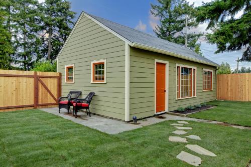 Small green and orange accessory dwelling unit in the back yard