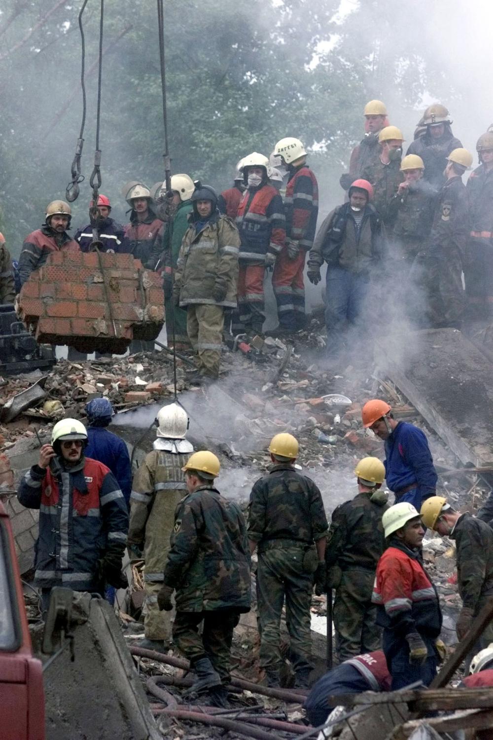 Rescue workers clean up the rubble of an eight-story Moscow building destroyed by a bomb September 13. The bomb destroyed an entire apartment block, killing at least 45 people, and prompting President Boris Yeltsin to order security measures to tackle a crisis that has struck at the very heart of Russia.