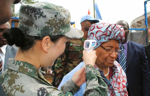 Liberia's President Ellen Johnson Sirleaf has her temperature taken by a Chinese paramedic before entering a new air-conditioned Chinese Ebola treatment unit (ETU) in the capital Monrovia November 25, 2014.
