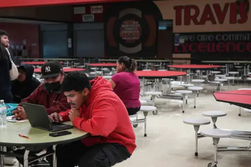 Jose and Neemias Ortiz fill out the FAFSA as Opportunity Austin hosts an informational event for students at Travis Early College High School on Wednesday, Feb. 7, 2024.