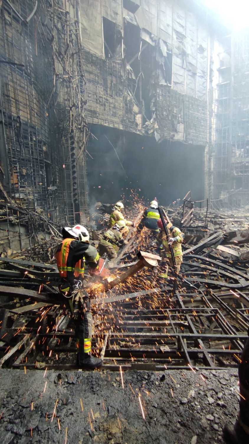 Members of the Russian Emergencies Ministry carry out search and rescue operations at the Crocus City Hall concert venue after a shooting attack and fire, outside Moscow, Russia, March 24, 2024.