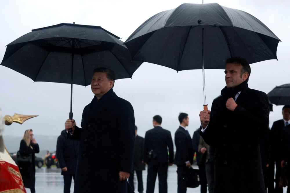 Chinese President Xi Jinping and French President Emmanuel Macron review the troops before Xi's departure from Tarbes Airport, France, May 7, 2024.