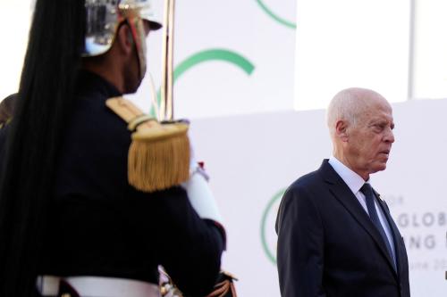 A soldier stands at attention as Tunisian President Kais Saied walks past