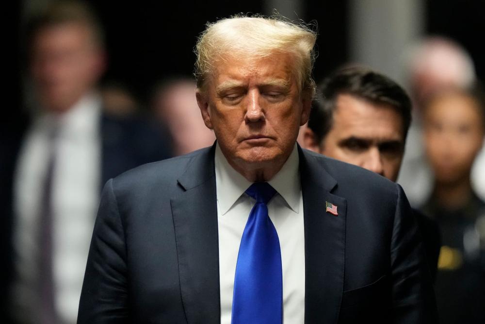 May 30, 2024; New York, NY, USA; Former President Donald Trump walks to make comments to members of the media after being found guilty on 34 felony counts of falsifying business records in the first degree at Manhattan criminal court. Trump became the first American president to be convicted of felony crimes as a New York jury found him guilty of 34 felony counts of falsifying business records in a scheme to illegally influence the 2016 election through hush money payments to a porn actor who said the two had sex.