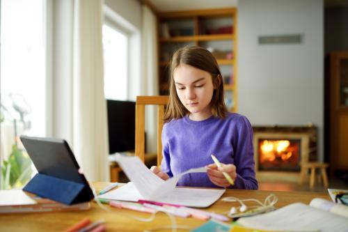 A girl learns at home through homeschooling