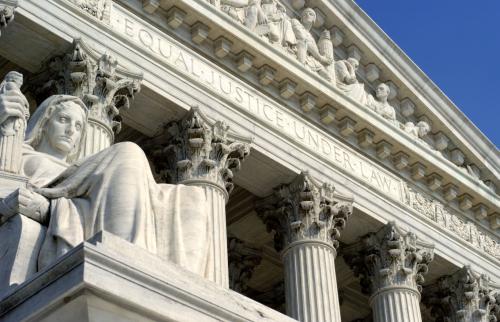 Image of the exterior of the United States Supreme Court, focusing on the portion of the pediment inscribed "Equal Justice Under Law" and James Earle Fraser's sculpture "The Contemplation of Justice"
