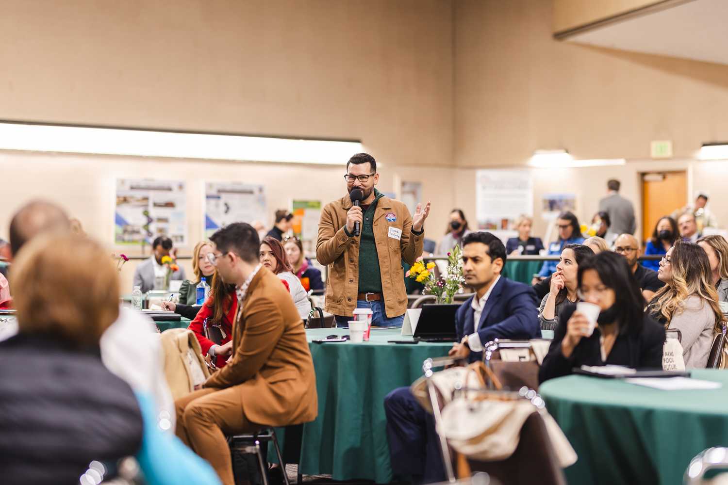 Man standing speaking at partners meeting