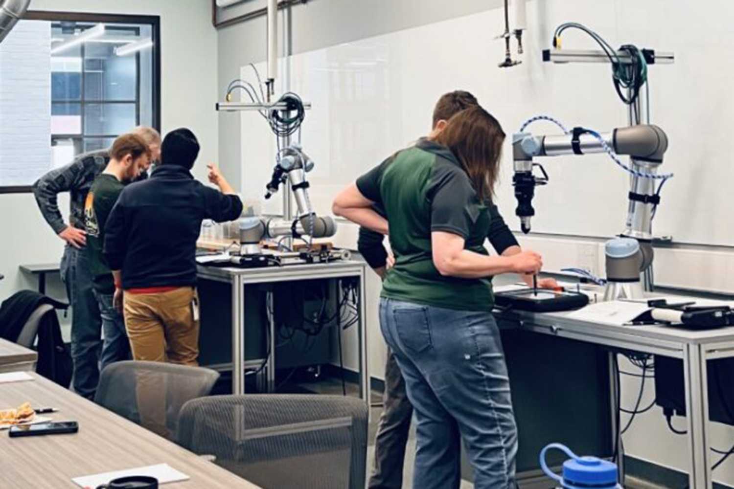 Shift 2.0 program participants in an automation training session for programming/operation of co-bot applications. This training prepares SMMs to actually bring such new technologies onto their factory floor.