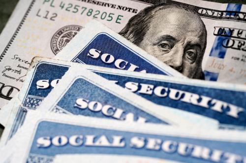 Image of Social Security cards and a $100 bill.