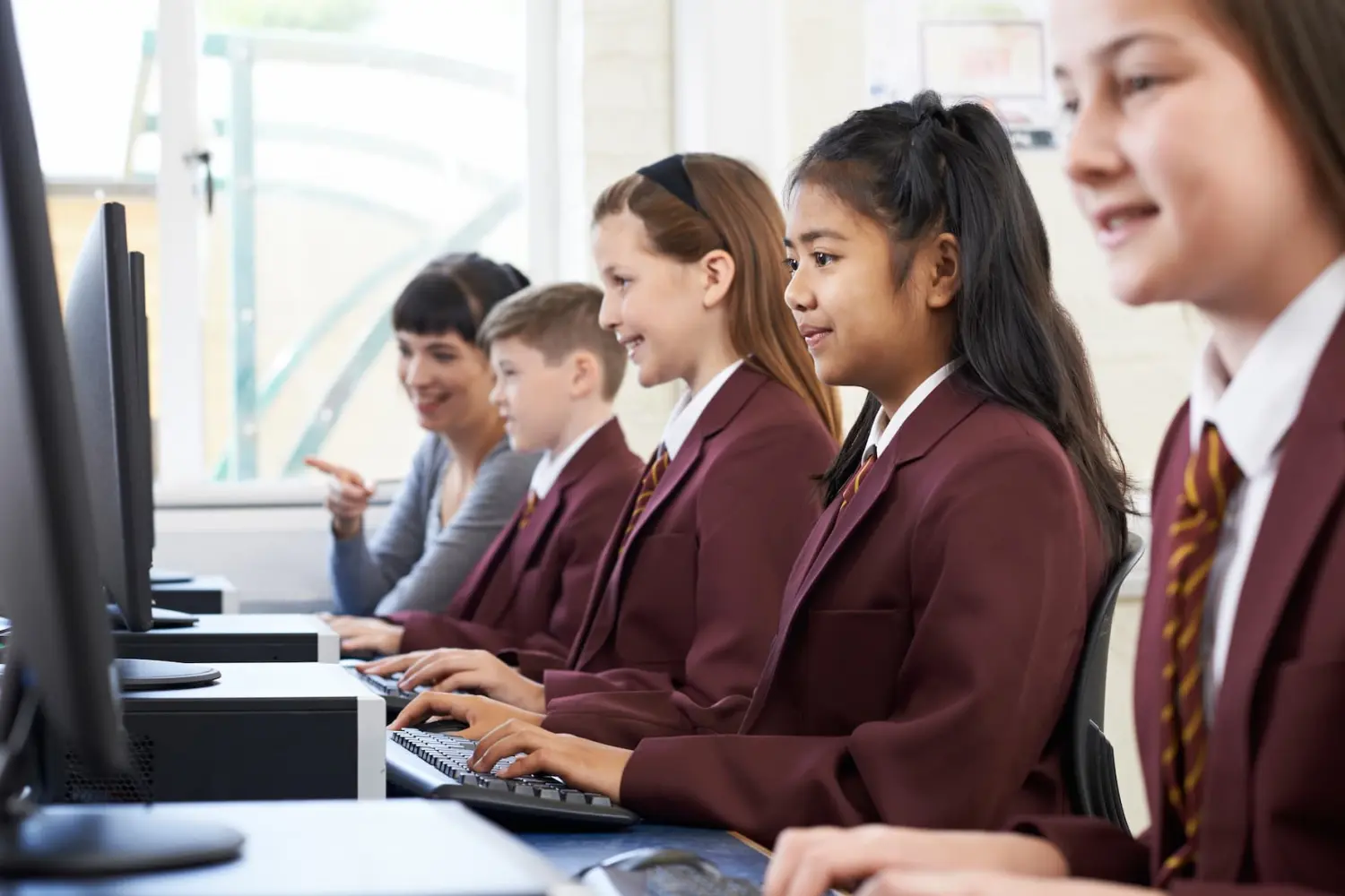 Pupils In Computer Class With Teacher