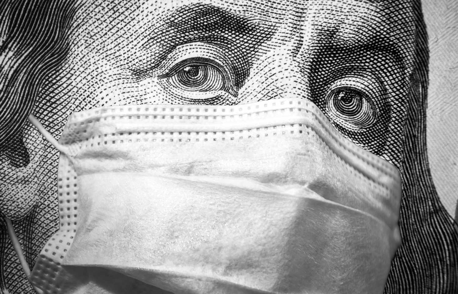 Close-up view of Ben Franklin on the $100 bill, wearing a surgical mask