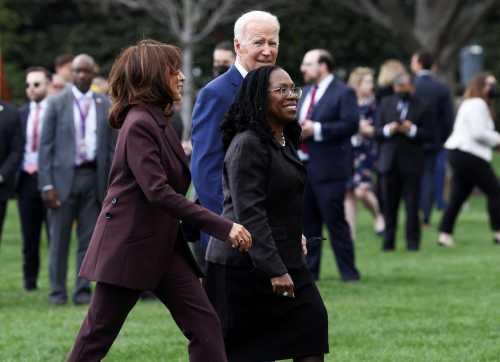 Judge Ketanji Brown Jackson walks back towards the White House with U.S. President Joe Biden and Vice President Kamala Harris after a celebration of Judge Jackson’s confirmation as the first Black woman to serve on the U.S. Supreme Court, on the South Lawn at the White House in Washington, U.S., April 8, 2022.