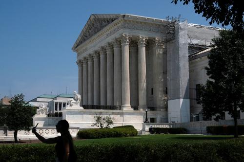 A pedestrian walks past the U.S. Supreme Court after President Joe Biden proposed sweeping changes to the nation's highest court, including term limits and a binding code of conduct for its nine justices, in Washington, U.S., July 29, 2024.