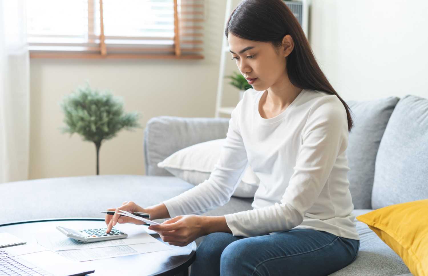 Asian American woman doing her taxes.