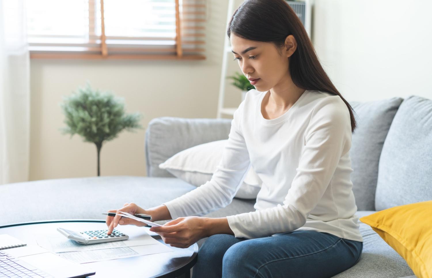 Asian American woman doing her taxes.