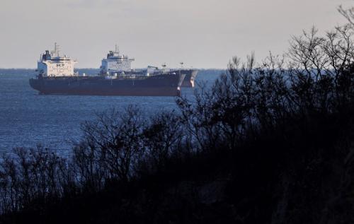 View from the shoreline of two oil tankers floating in the sea