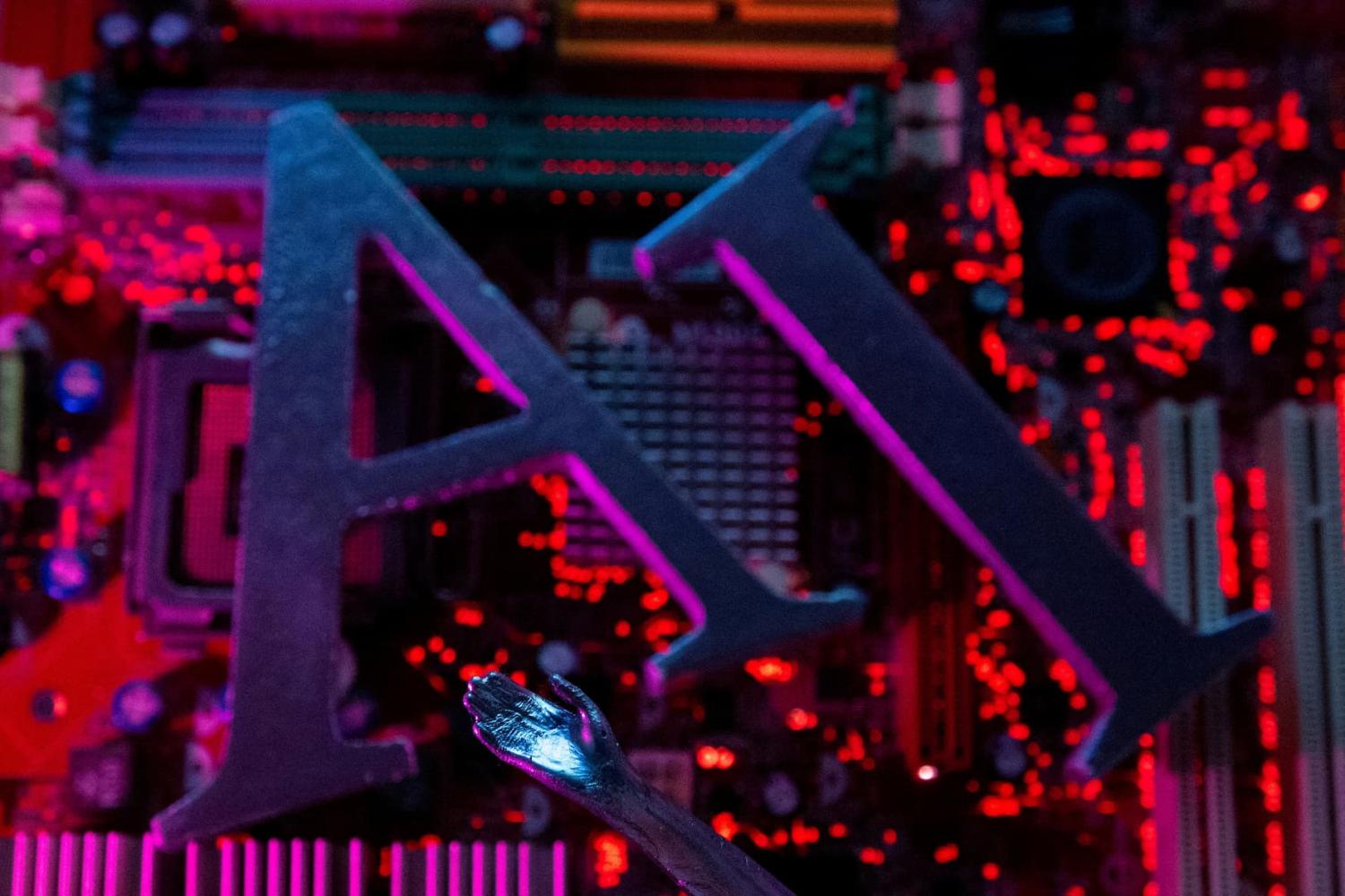 AI (Artificial Intelligence) letters and robot hand are placed on computer motherboard in this illustration taken, June 23, 2023.