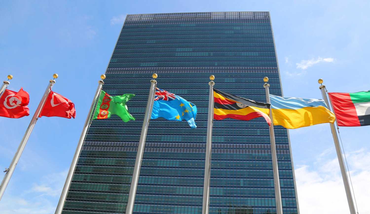Member country flags fly in front of UN headquarters in New York
