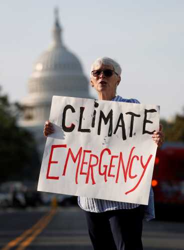 Environmental activists block traffic as part of "Shut Down DC" protests seeking to pressure U.S. politicians to fight climate change in Washington, U.S., September 23, 2019. REUTERS/Kevin Lamarque
