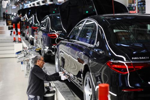 A worker attaches a part to a Mercedes-Maybach car on a production line of "Factory 56," one of the world's most modern electric and conventional car assembly halls of German carmaker Mercedes-Benz, in Sindelfingen near Stuttgart, Germany, March 4, 2024.