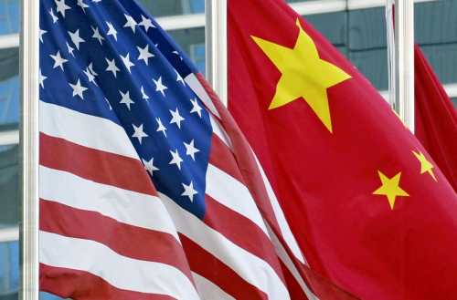 National flags of China and the United States are raised in Beijing on October 8, 2024.