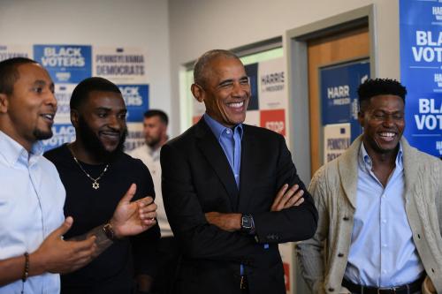 Former President Barack Obama laughs as he listens to an introduction at a campaign field office in East Liberty, ahead of a rally in support of Vice President Kamala Harris, in Pittsburgh, Pennsylvania, U.S., Thursday, Oct. 10, 2024.