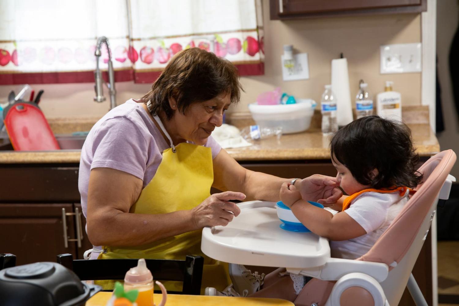 Marta Aguirre feeds Lupita Aguirre at their home in Phoenix, Arizona, U.S. on April 19, 2022.