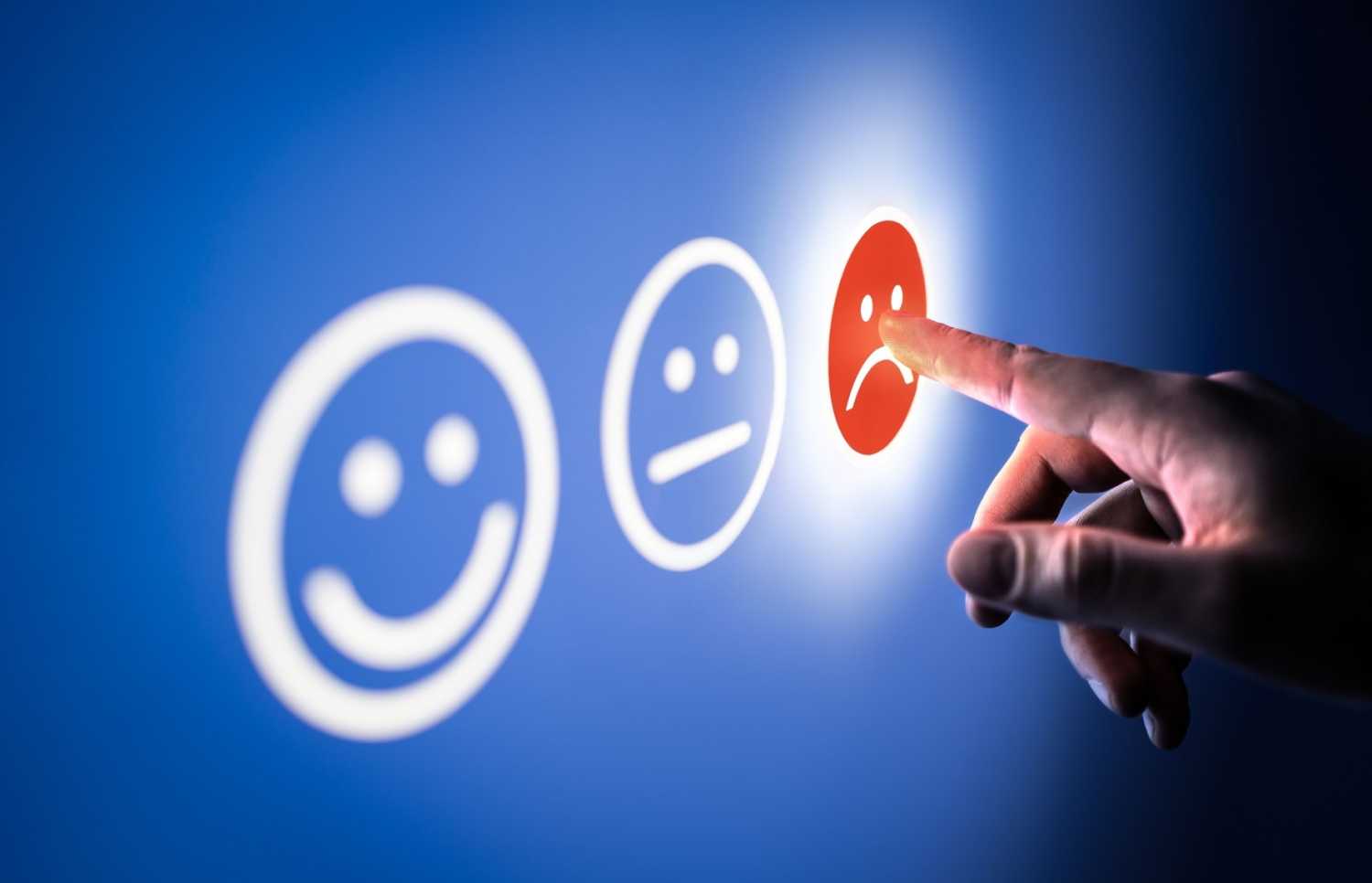 Finger pointing at bad smiley on a scale