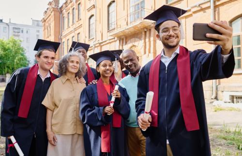 a group of new college graduates posing for a photo with their families