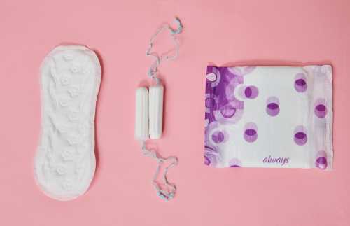 Tampons, a panty liner, and a sanitary napkin from different manufacturers are shown on a table in a photo taken on November 27, 2020.