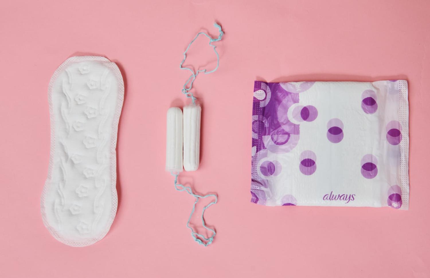 Tampons, a panty liner, and a sanitary napkin from different manufacturers are shown on a table in a photo taken on November 27, 2020.