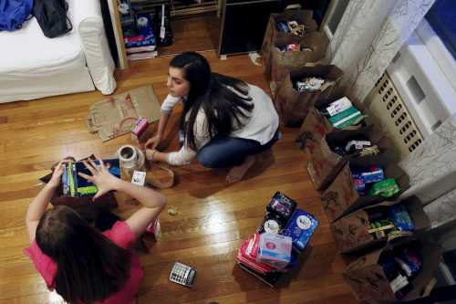 Emma Joy (R), 16, and her sister Quinn, 12, pack feminine products for delivery at their home in South Orange, New Jersey March 6, 2016. The South Orange, New Jersey, residents got the idea for their charity, Girls Helping Girls Period, when Emma learned that federal assistance programs for the indigent do not cover menstruation products, leaving many low-income and homeless women to cope with their cycles on their own.